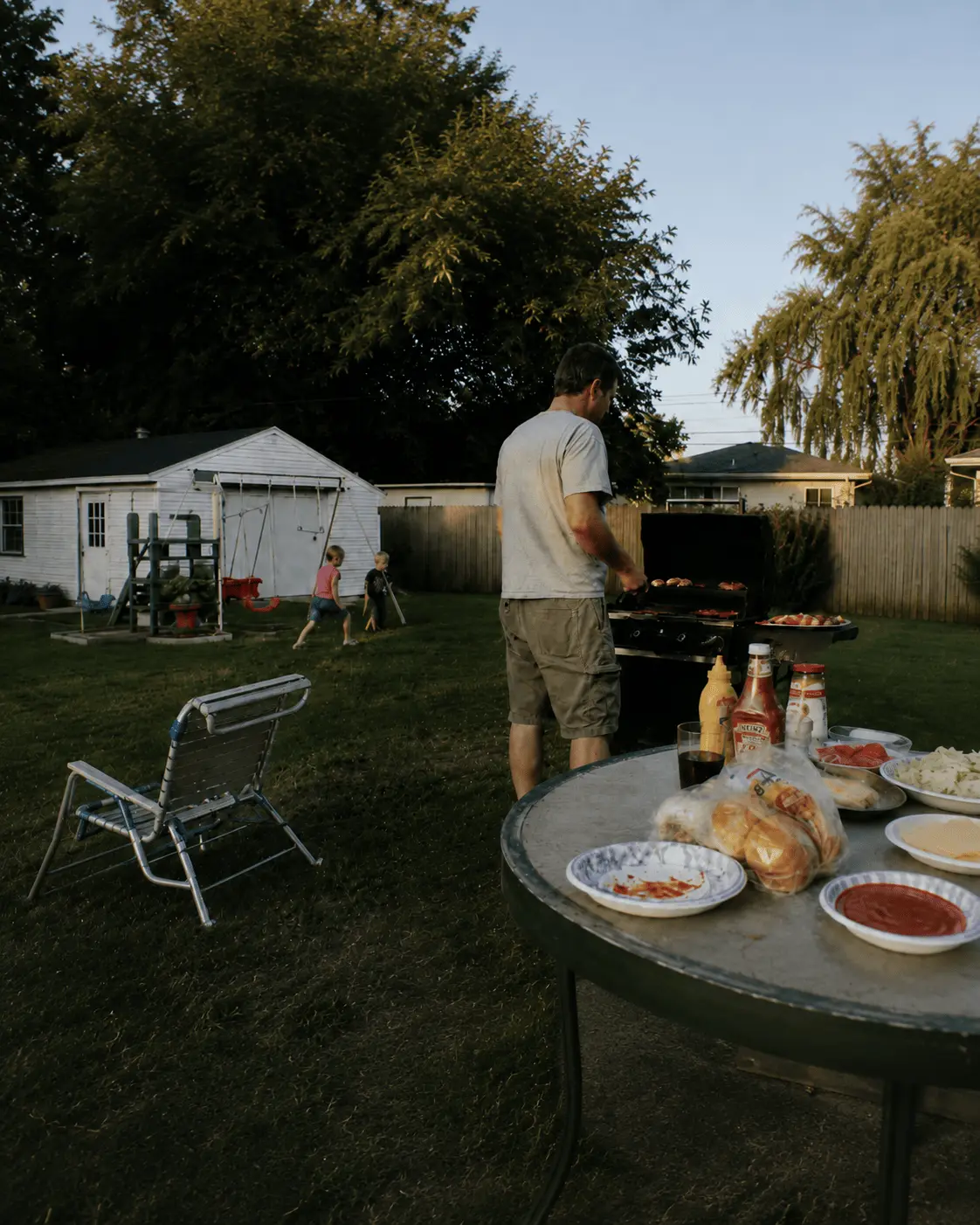 Family backyard cookout at dusk